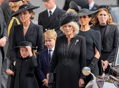 Kate, Princess of Wales, outside Westminster Abbey following the queen's funeral service with Princess Charlotte, Prince George, Queen Consort Camilla, Meghan, Duchess of Sussex, and Princess Beatrice. AP