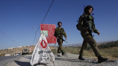 Israeli soldiers at a temporary checkpoint in the occupied West Bank. Hazem Bader / AFP