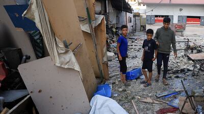 Palestinians inspect the damage at a school sheltering displaced people, following an overnight Israeli air strike, in Gaza city. Reuters