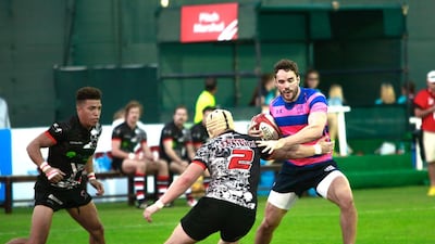 Thom Evans, right, of UR7s Wanderers, scores two tries in his first game back since a neck injury five years ago. Victor Besa for The National