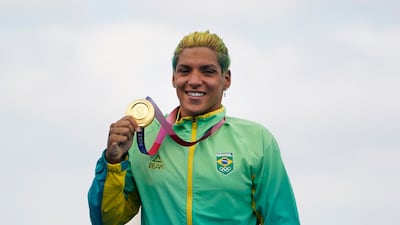 Ana Marcela Cunha, of Brazil, poses with her gold medal during a victory ceremony for the women's marathon swimming event.