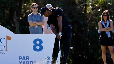 Tiger Woods hits his tee shot on the 8th hole. Reuters