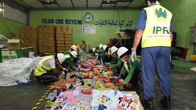 Dubai Customs officials pictured with counterfeit goods that have been seized. Courtesy: Dubai Customs