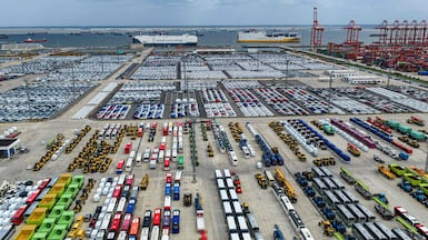 Vehicles at a dock before being loaded on to ships for export at Suzhou port in China. The WTO says global trade has expanded nearly fifty-fold in the past eight decades. AFP
