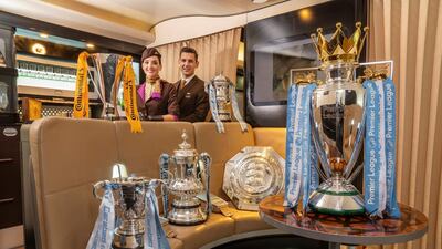 Etihad Airways staff with the six trophieds won collectively by Manchester City's men's and women's teams in 2018/19. Handout photo