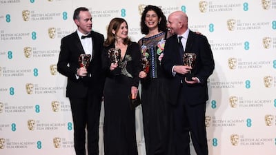 John Crowley, Finola Dwyer, Amanda Posey and Nick Hornby pose with the Outstanding British Film award for Brooklyn in the winners room. Ian Gavan / Getty Images