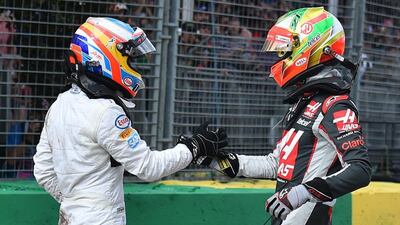 McLaren driver Fernando Alonso, left, of Spain and Haas driver Esteban Gutierrez of Mexico shake hands following a collision during the Australian Grand Prix at Albert Park in Melbourne, Australia, Sunday, March 20, 2016. (AP Photo/Theo Karanikos)