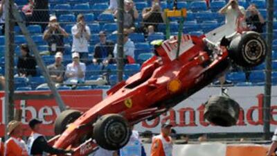 Felipe Massa's damaged Ferrari is lifted off the Silverstone track.