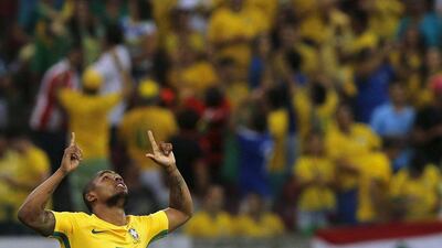 Douglas Costa of Brazil celebrates after scoring a goal against Uruguay. REUTERS/Paulo Whitaker