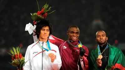 Qatar’s 200m gold medalist Femi Ogunode, centre, poses on the podium with Japan’s Kenji Fujimitsu, left, and the UAE’s Omar al Salfa.