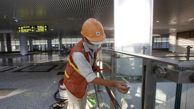 A worker cleans glass panels at the new terminal of Noi Bai international airport in Hanoi. The four-storey facility has been built since December 2011 by a workforce of 1,300 people. Kham / Reuters