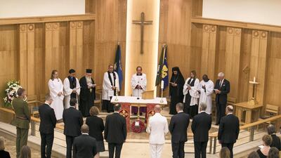 The British Ambassador, Philip Parham, placed the Poppy Wreath of Remembrance against the plinth of the altar at St Andrew's Church. Reem Mohammed / The National