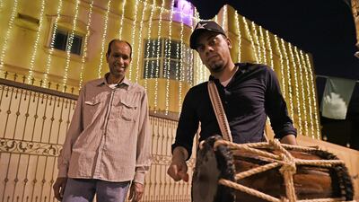 Yasser al Samak, right, the dawn awakener known as Musaharati, walks through streets to wake up worshippers for a meal before sunrise during Ramadan in Bilad Al Qadeem suburb of the Bahraini capital Manama. AFP