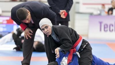 Maitha Harasi, black, fights Shamsa Hasan, during a Female Blue Adult 55KG match at Al Ain Jiu Jitsu Open Championship. Reem Mohammed / The National