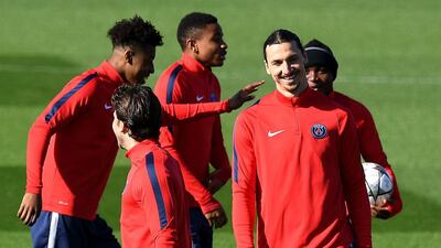 Paris Saint-Germain’s Swedish forward Zlatan Ibrahimovic, right, smiles during a training session on April 5, 2016 in Saint-Germain-en-Laye, western Paris, on the eve of the team’s UEFA Champions League football match against Manchester City. Franck Fife / AFP
