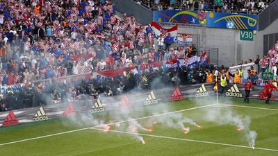 Flares are thrown onto the pitch by fans during their Euro 2016 Group D match between Croatia and Czech Republic in Saint-Etienne. Max Rossi / Reuters