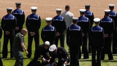 A marine who collapsed during the ceremony is attended to. Reuters