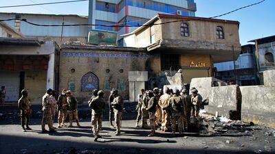 Iraqi security forces deploy in Al Rashid Street. AP