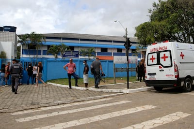 An ambulance waits outside the Primo Bitti state school after a 16-year-old former student went on a shooting spree there and at another school in Aracruz city, Brazi. AFP