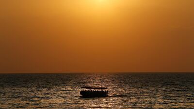 A boat carrying migrants sails off the coast of the northern Lebanese city of Tripoli. AP