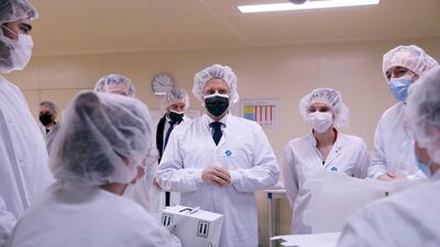 French President Emmanuel Macron talks to employees as he visits the Delpharm plant in Saint-Remy-sur-Avre, west of Paris. The Delpharm plant started bottling the Pfizer-BioNTech vaccines this week as France tries to make its mark on global vaccine production against Covid-19, and speed up vaccinations of French people amid a new virus surge. AFP