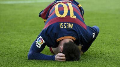 Barcelona’s Lionel Messi reacts after a challenge from Filipe Luis on Saturday in their La Liga match at the Camp Nou. Josep Lago / AFP