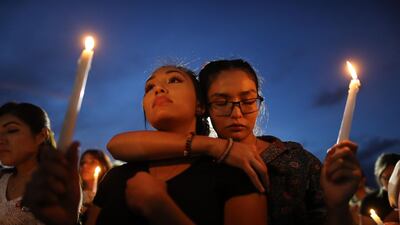 People attend a candlelight vigil at a makeshift memorial honoring victims of a mass shooting which left at least 22 people dead, on August 7, 2019 in El Paso, Texas. AFP