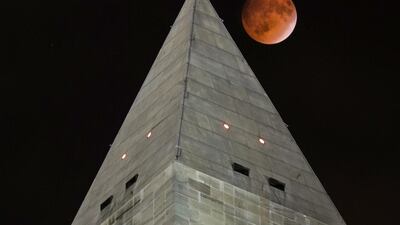 The so-called supermoon passes behind the peak of the Washington Monument during a lunar eclipse. J. David Ake AP Photo