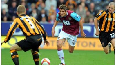 West Ham's Valon Behrami, centre, deals with the attentions of two Hull City players.