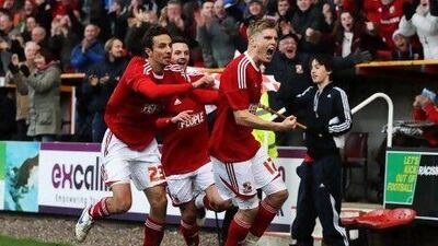 SWINDON, ENGLAND - JANUARY 07: Alan Connell of Swindon Town (R) celebrates with team mates as he scores their first goal during the FA Cup sponsored by Budweiser Third Round match between Swindon Town and Wigan Athletic at the County Ground on January 7, 2012 in Swindon, England. (Photo by Scott Heavey/Getty Images) *** Local Caption *** 136532242.jpg
