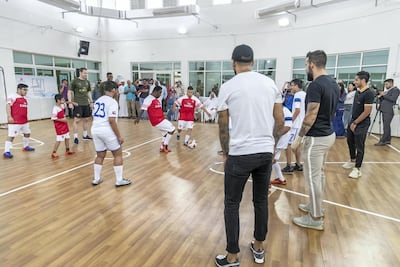 Players from Arsenal and Al-Nasr take on children from the centre