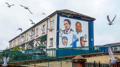 Pigeons fly past a mural depicting John Hume and other Nobel laureates, Martin Luther King Jr, Mother Teresa and Nelson Mandela in Derry, Northern Ireland. AFP