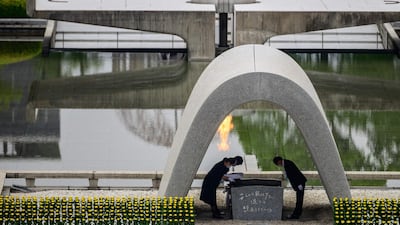 Hiroshima mayor Kazumi Matsui, right, and representatives of bereaved families take part in a ceremony at the Memorial Cenotaph during the 75th anniversary memorial service for atomic bomb victims at the Peace Memorial Park in Hiroshima on August 6, 2020. AFP