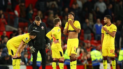 Sheffield United players after the defeat at Old Trafford leaves them on the brink of relegation. Reuters
