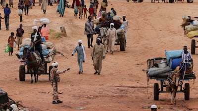 Chadian cart owners transport belongings of Sudanese people who fled the conflict in Sudan's Darfur region. Reuters