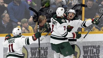 Minnesota Wild defenceman Jared Spurgeon, right, celebrates with right wing Chris Stewart and left wing Zach Parise. Mark Zaleski / AP