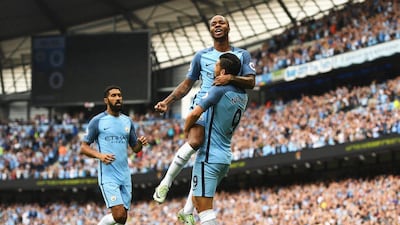 Raheem Sterling celebrates with teammates. Gareth Copley / Getty Images