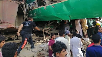 People gather at the scene of a train accident near the city of Sadiqabad in Pakistan's Punjab province on July 11, 2019. EPA