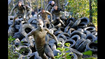Participants cross a car tires obstacle during the Wild Boar Dirt Run in Laaben near Vienna. Leonhard Foeger / Reuters