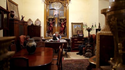 An owner of an antiques shop sits at his store in Fouad street in Alexandria.
