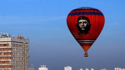A hot-air balloon showing a portrait of Argentinian Marxist revolutionary Ernesto “Che” Guevara flies over buildings on the outskirts of Minsk during the International festival of aeronautics. Sergei Gapon / AFP