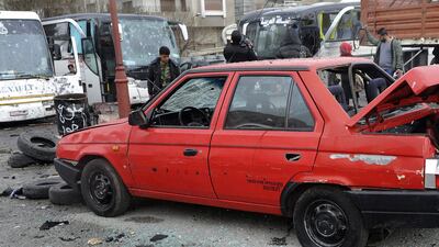 Syrians inspect the damage to a Damascus car park following twin explosions on March 11, 2017. Sana via AP