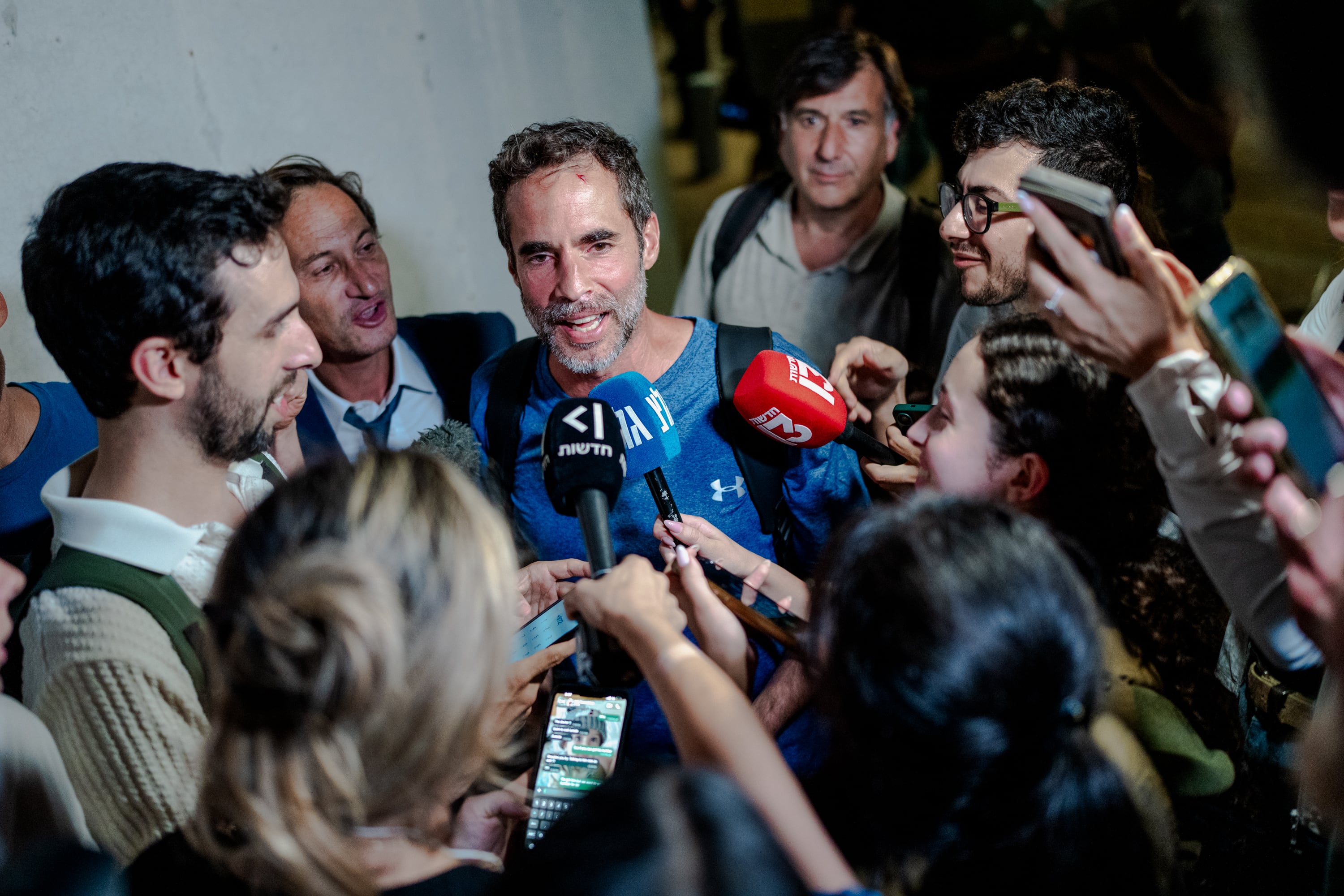 Assaf Regavim, who filmed a video from inside the cabin and helped to overpower the attacker, talks to reporters at Ben Gurion Airport. Getty Images