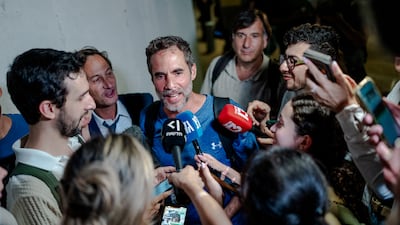 Assaf Regavim, who filmed a video from inside the cabin and helped to overpower the attacker, talks to reporters at Ben Gurion Airport. Getty Images