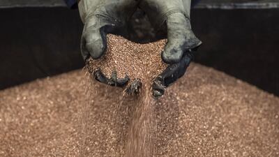 A worker handles copper shavings at a foundry. Bloomberg