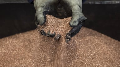 A worker handles copper shavings at a foundry. The metal is essential for efficient electrical systems. Bloomberg