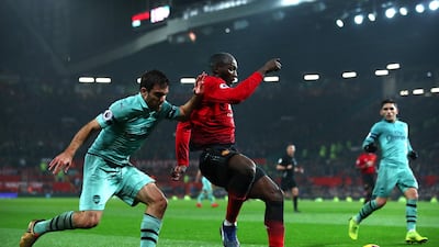 Sokratis Papastathopoulos of Arsenal battles for possession with Romelu Lukaku of Manchester United. Getty Images