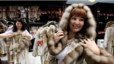 "They come for holiday and they pick up a fur coat": A Russian tourist tries on a mink at Dolce Moda.