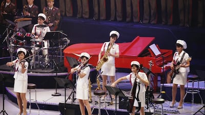 In this Oct. 11, 2015, photo, members of North Korea's Moranbong Band perform with the State Merited Chorus in Pyongyang, North Korea. Before it all fell apart, a visit to Beijing by North Korea’s most popular all-female pop group formed by leader Kim Jong Un was touted by Pyongyang as the perfect chance to warm up relations with its biggest and most important ally. But the much-anticipated international debut of the Moranbong Band at Beijing’s National Theater last weekend was nixed just hours before it was to begin and the ladies hopped the first flight back to Pyongyang. (AP Photo/Charles Dharapak)