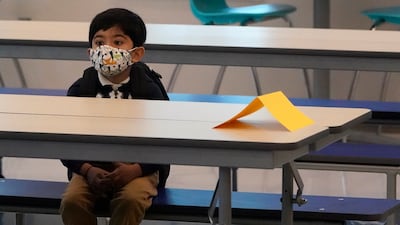 A student waits in the cafeteria after eating breakfast, on August, 10, 2021, during the first day of school at Washington Elementary School in Riviera Beach, Florida. AP